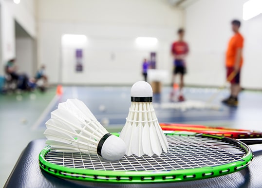 Engage in indoor badminton at Central Park Clover Floors